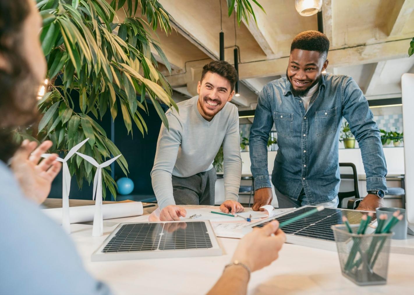 Business team reviewing financial projections on laptop screen